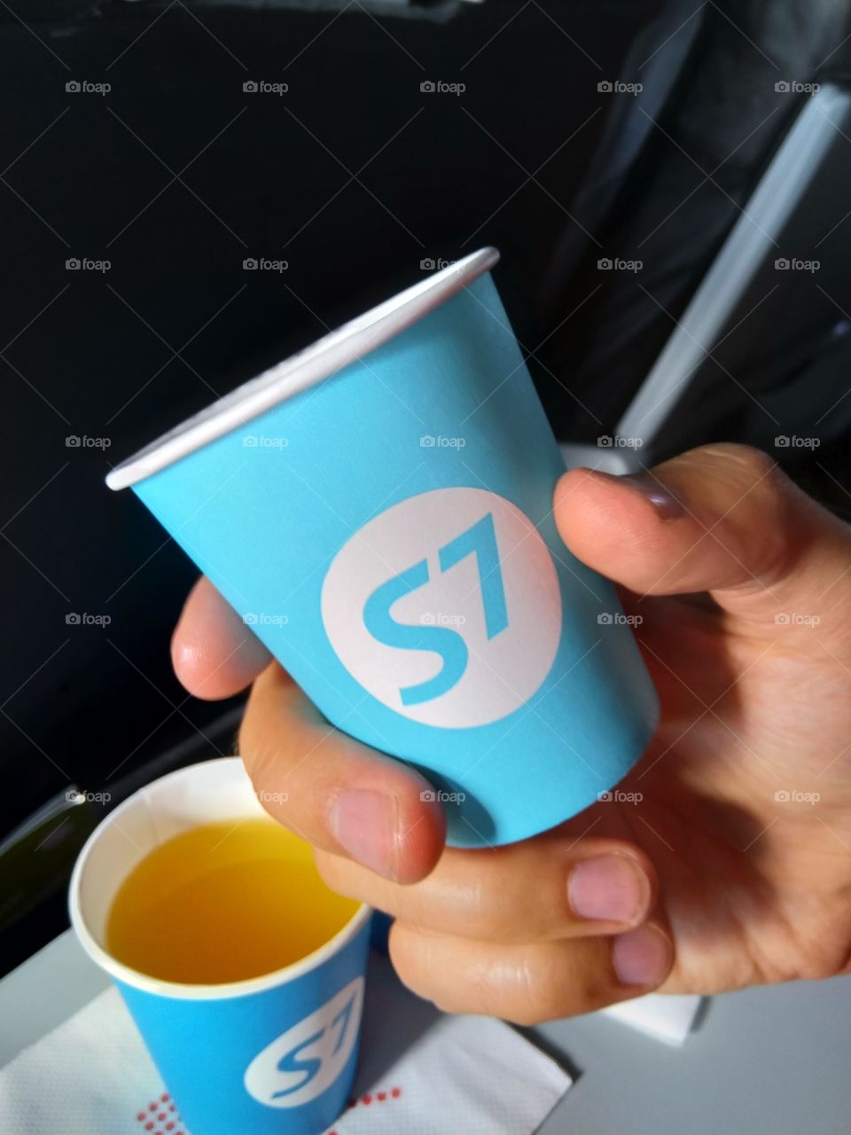 Paper Cup of juice on the plane