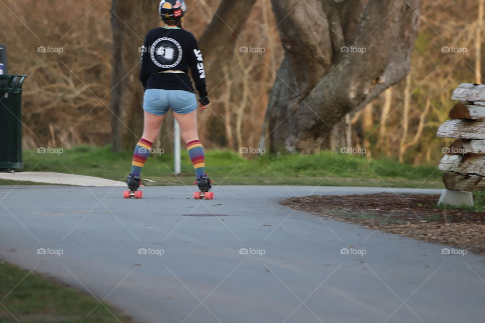 Young woman riding on rollerblades 