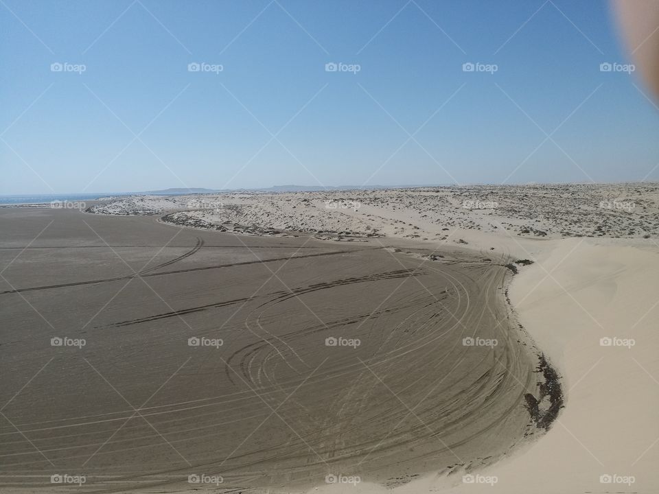 tire tracks in sand dune