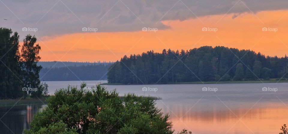 Orange glowing summer evening sky in Western Finland.