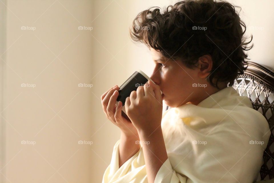 girl drinking a mug of tea