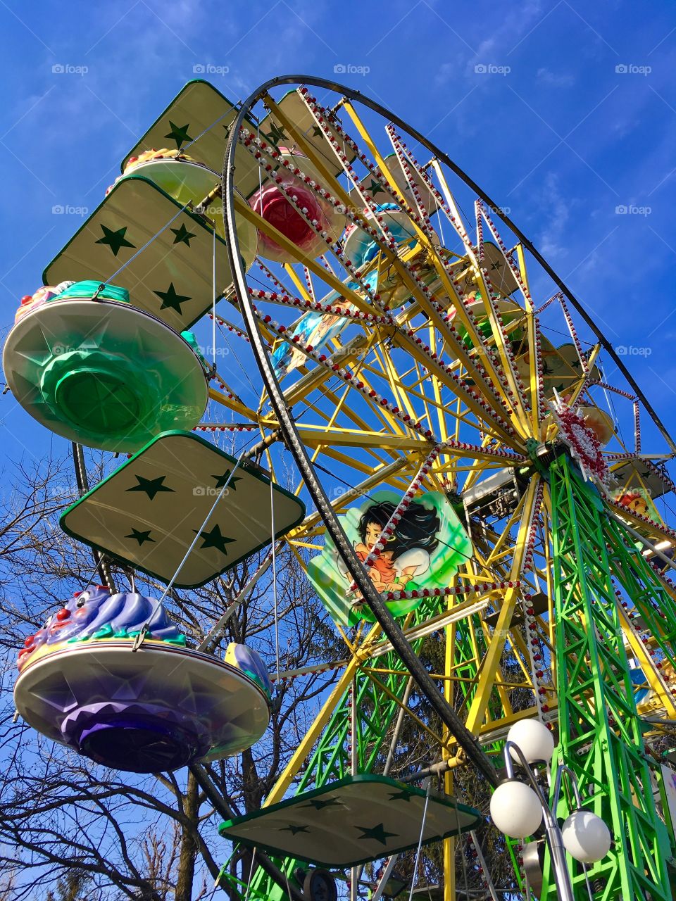 Colorful ferris wheel on a blue sky background