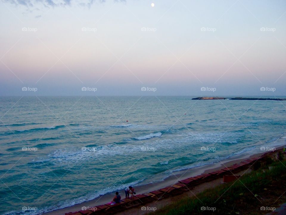 Night begins to fall on the sea coast