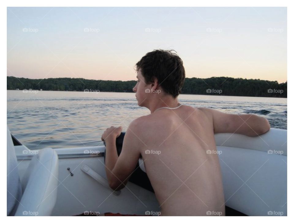 Boy looking off Boat