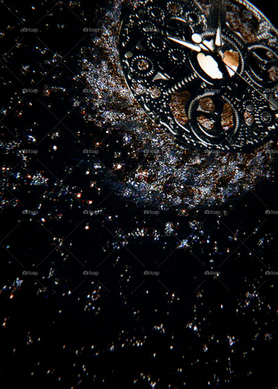 Time. Clock mechanism on the background of the galaxy