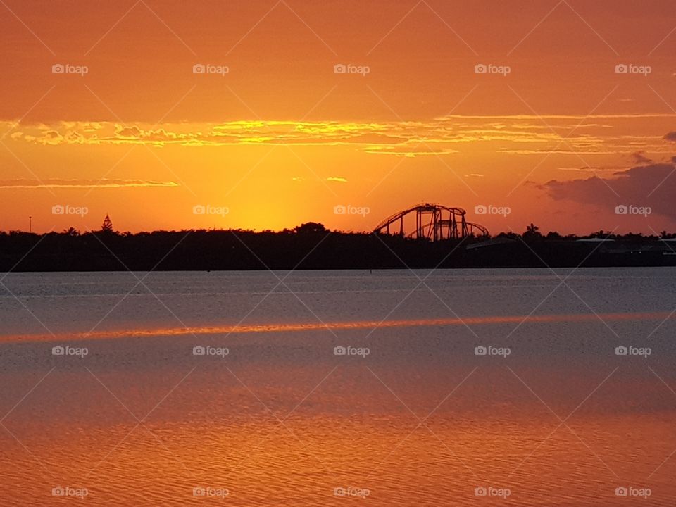 First light shining over theme park