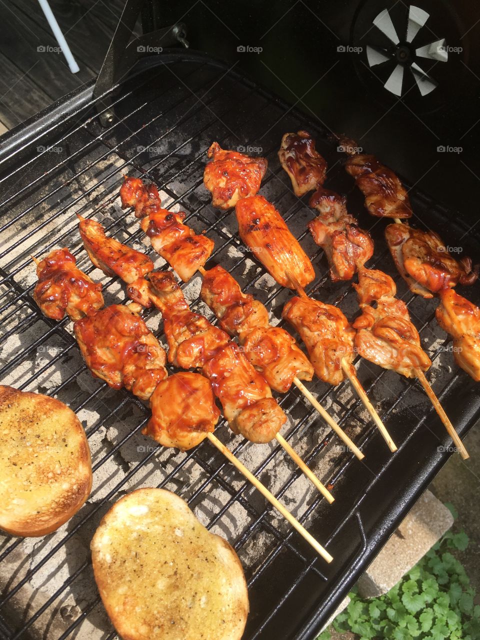 Barbecue  chicken thighs on kabob sticks, with roasted garlic Parmesan bread.  Happy Fourth of July!
