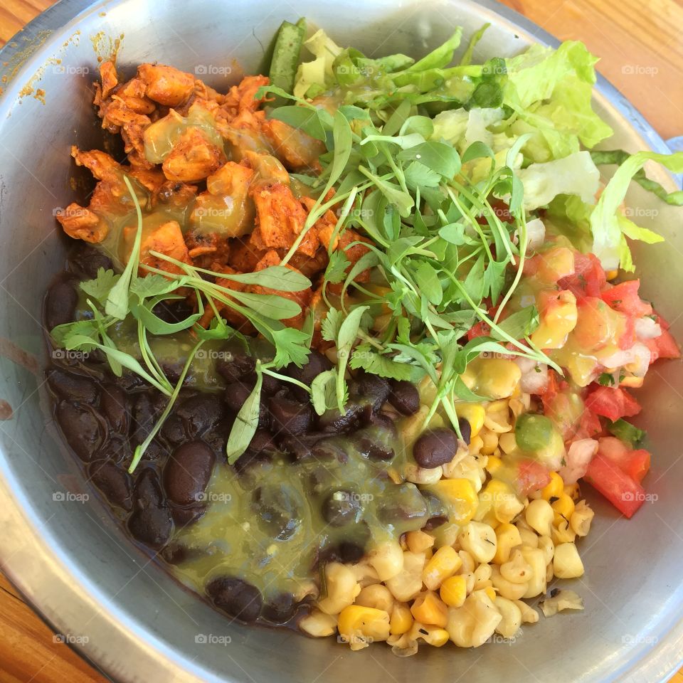 Chicken bowl with pico de gallo, salsa, black beans, corn, and fresh herbs 