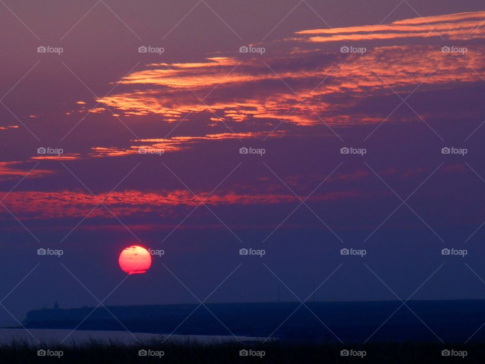 beautiful sunset over the sea and steppe landscape