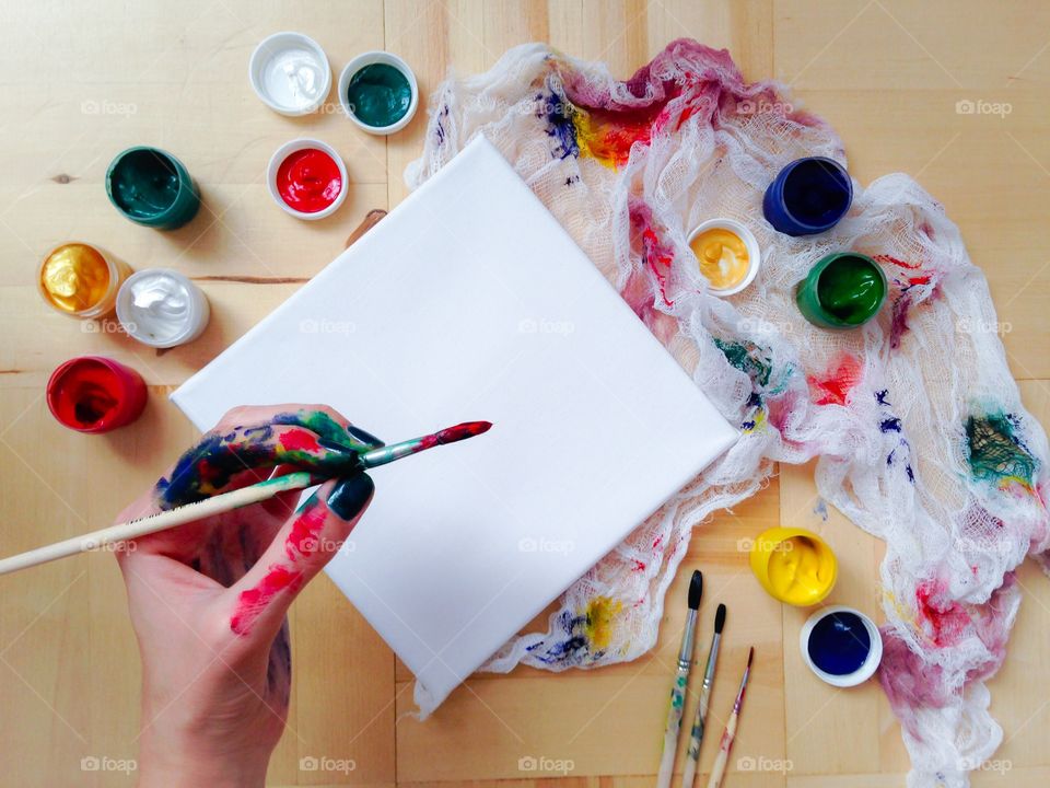 A woman holding paintbrush