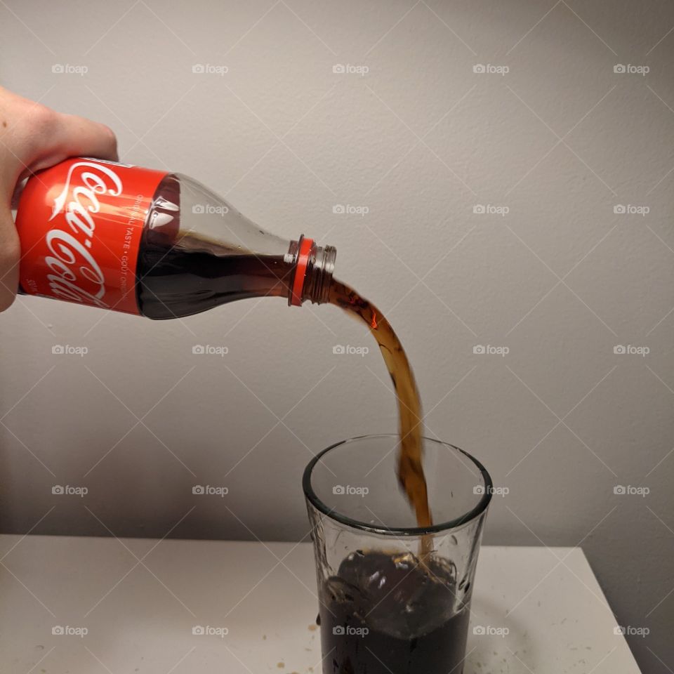 pouring a refreshing glass of Coke