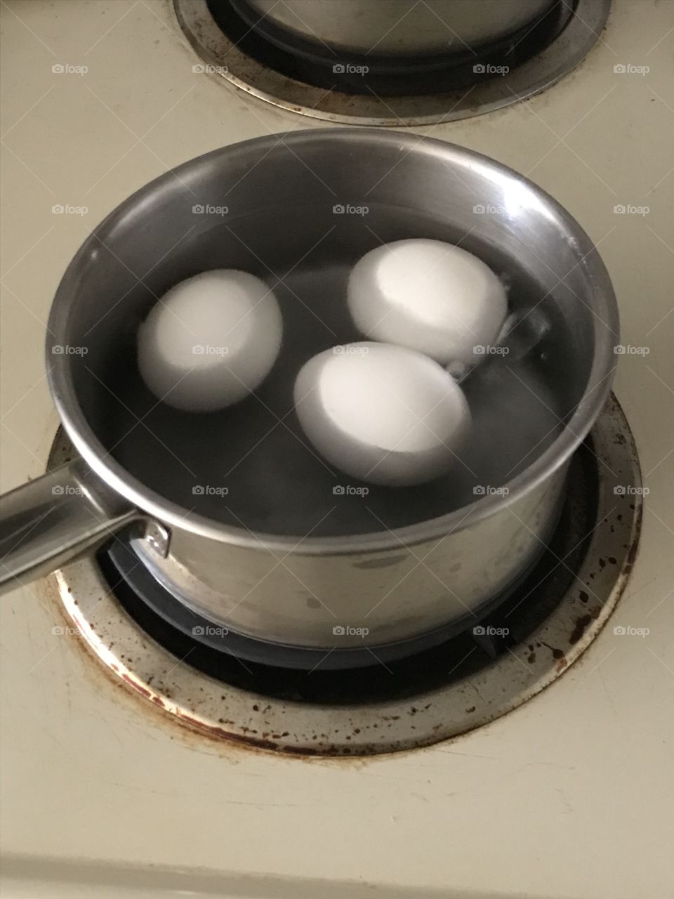 Eggs broiled in a pan of water to the broiling point. A simple way to prepare them for healthy consumption.
