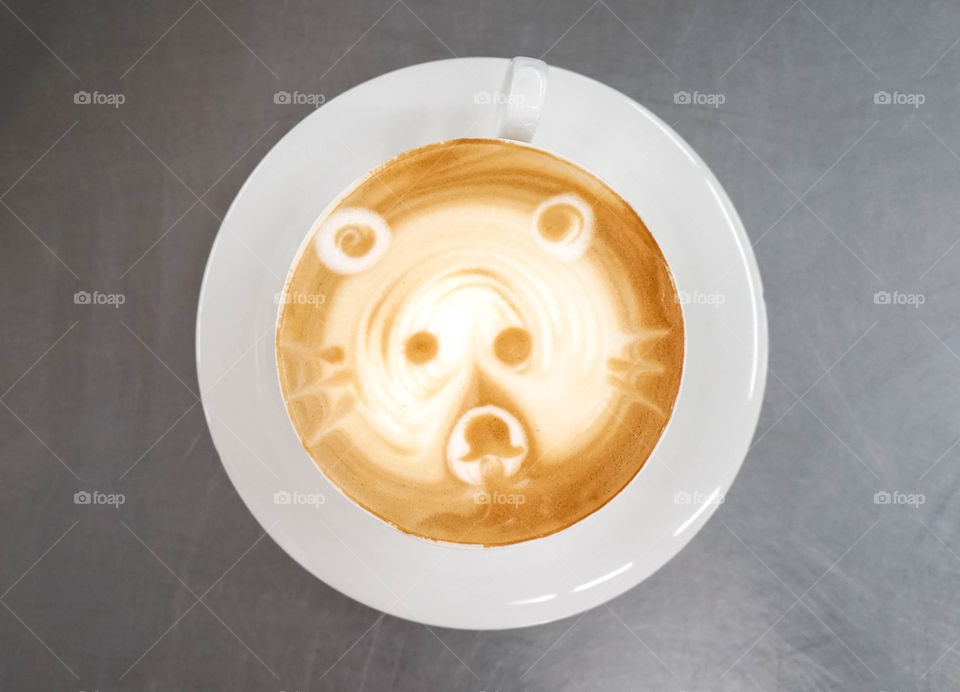 Latte art, coffee latte top view. Cute bear in latte art.