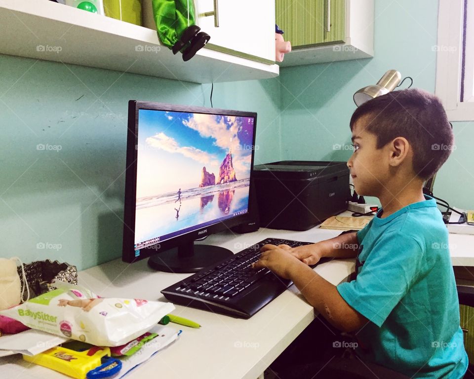 A kid using a computer 