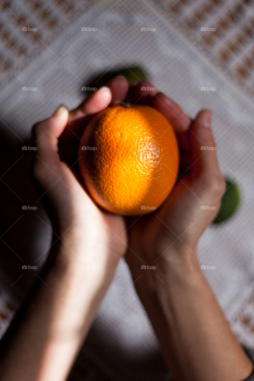 Woman holding orange fruit