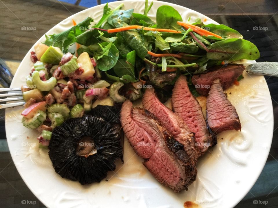 Roast lamb with fresh green salad and grilled mushrooms 