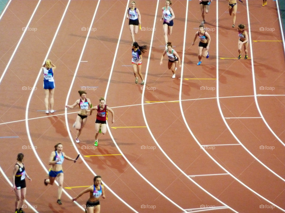 women race relay baton-change by lizajones
