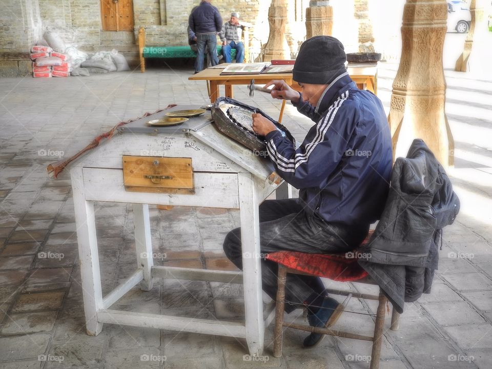 Took this picture when I was walking in old town of Bukhara. It was fun to watch that guys working. 