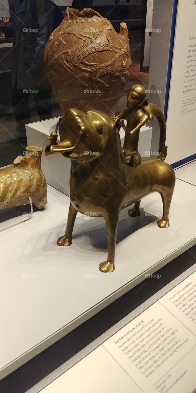 metal dog statue in museum display case