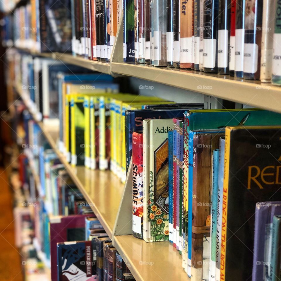 A row of library books in the young readers fiction section  of a local library.