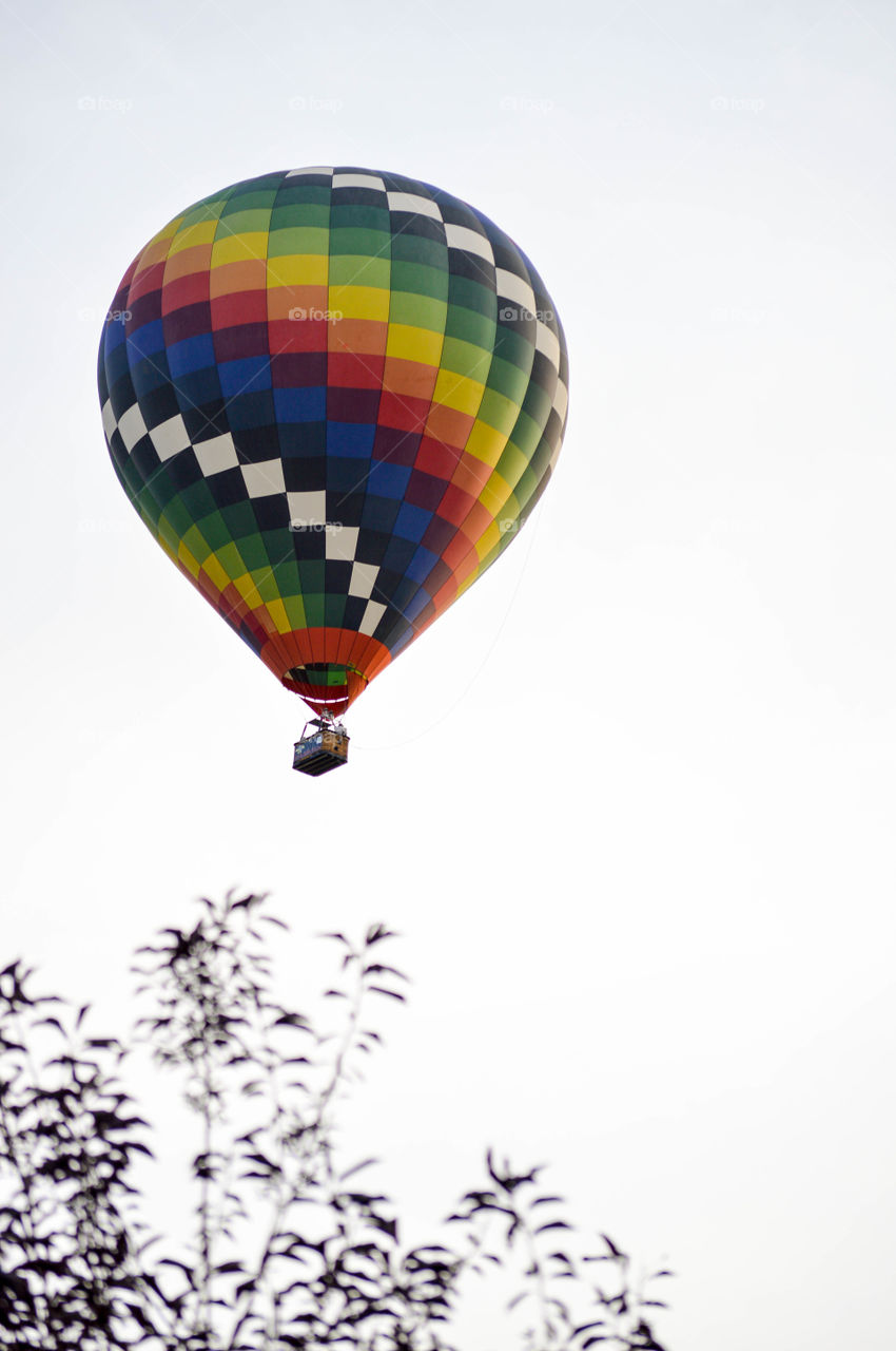 Rainbow colored hot air balloon in the sky