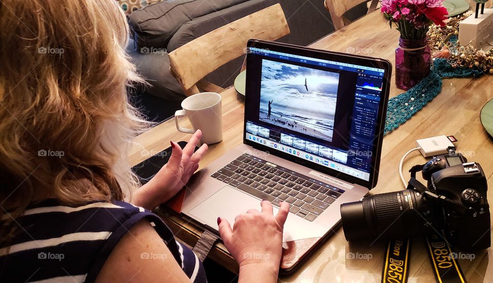 lady editing photos for website on computer...