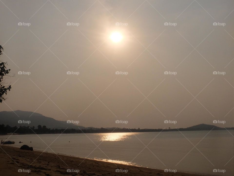 Sun glistening off the flat ocean 