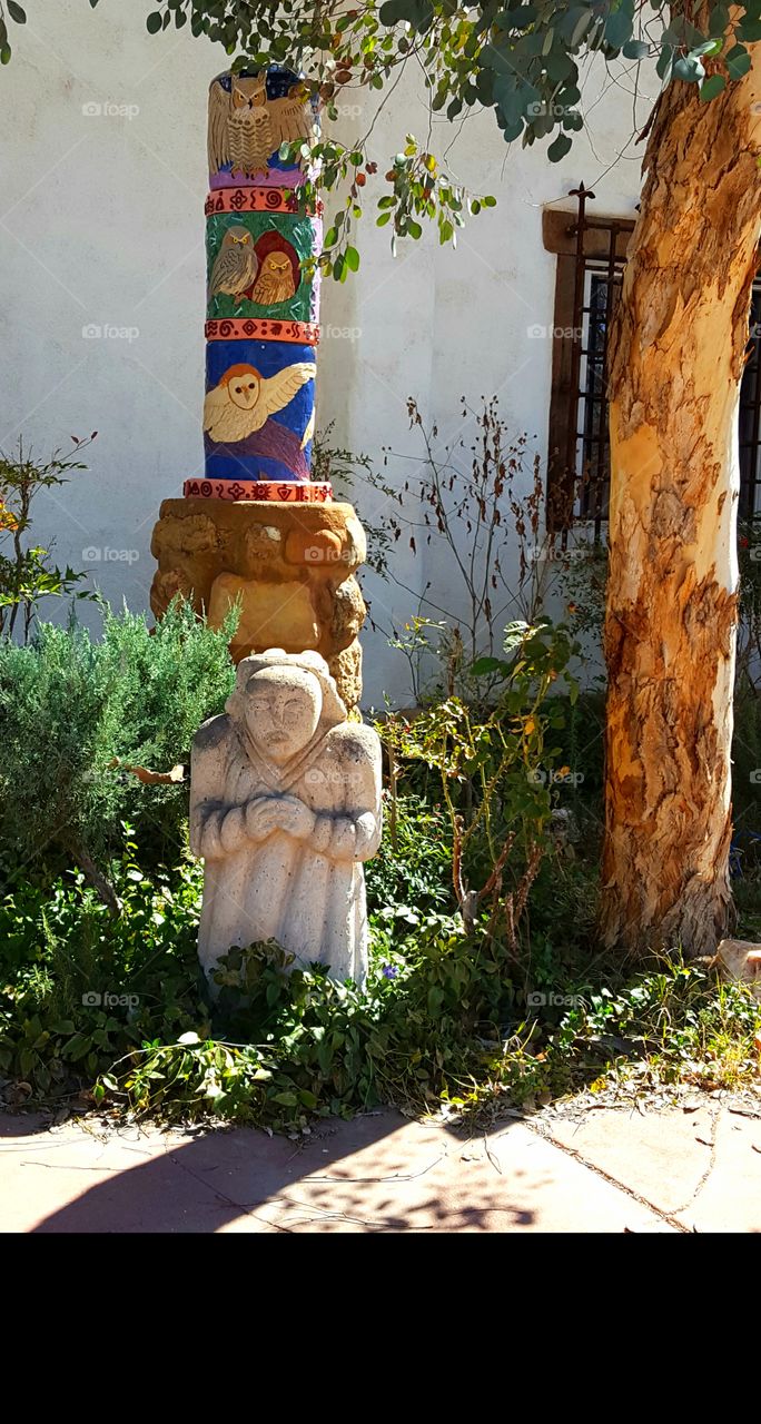 Statue in front of old church converted to a home