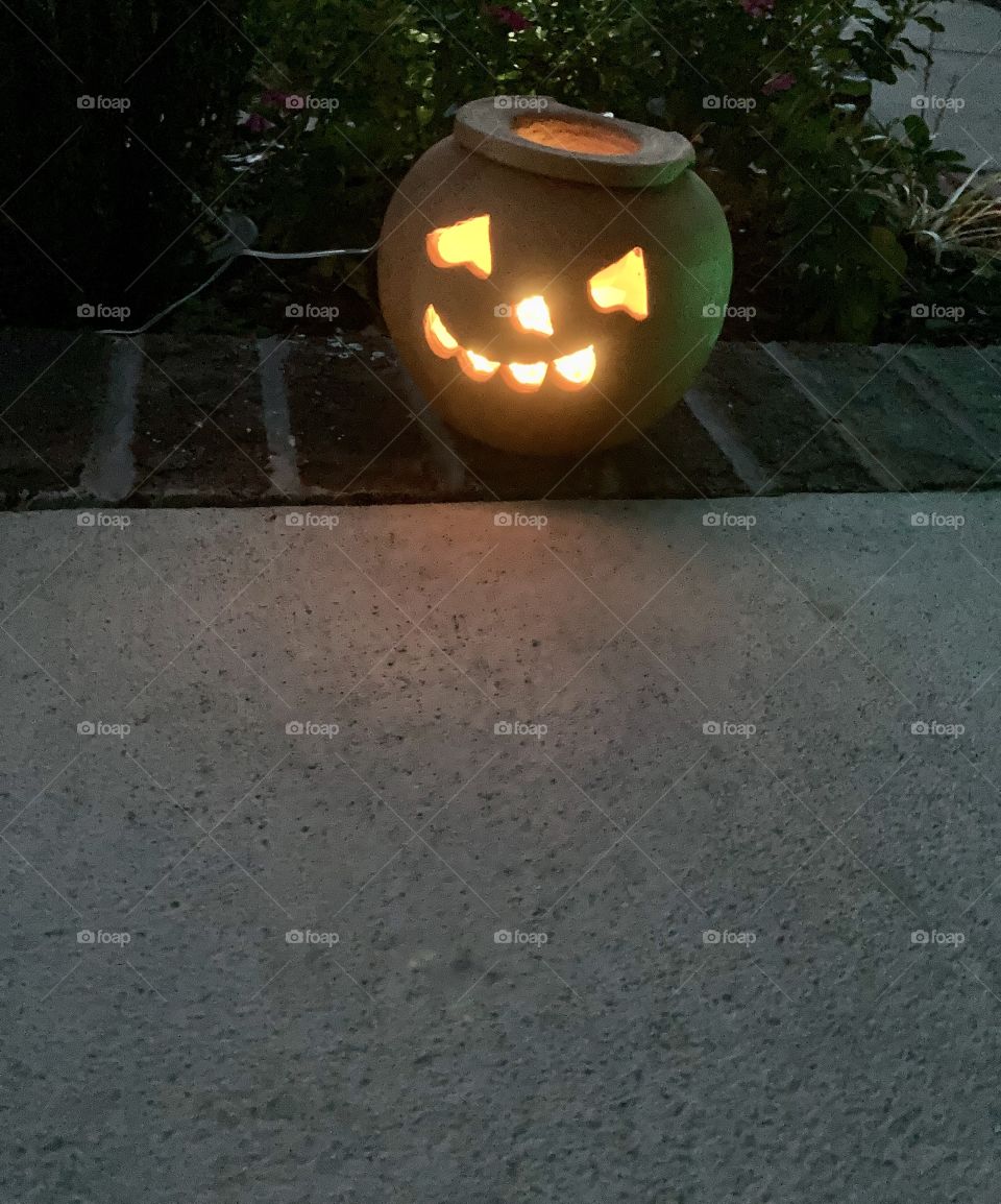 Jack o lantern on porch at night