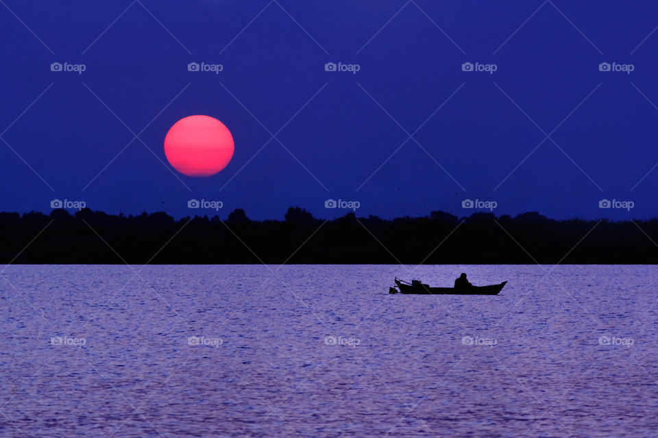 Sunset at Galuh Cempaks Lake, Banjarbaru, South Borneo, Indonesia.
