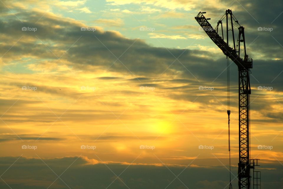 working crane sunset