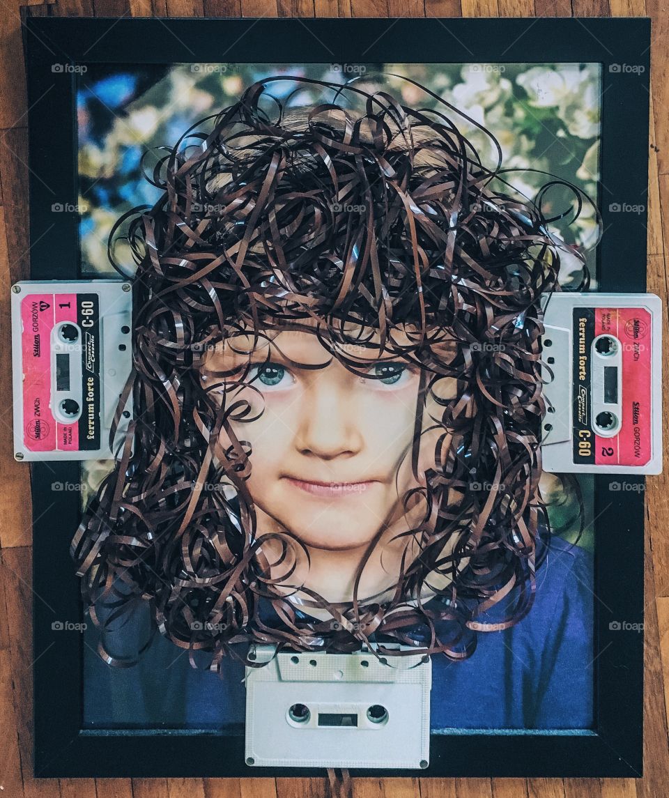Small child in photo frame with cassette reel