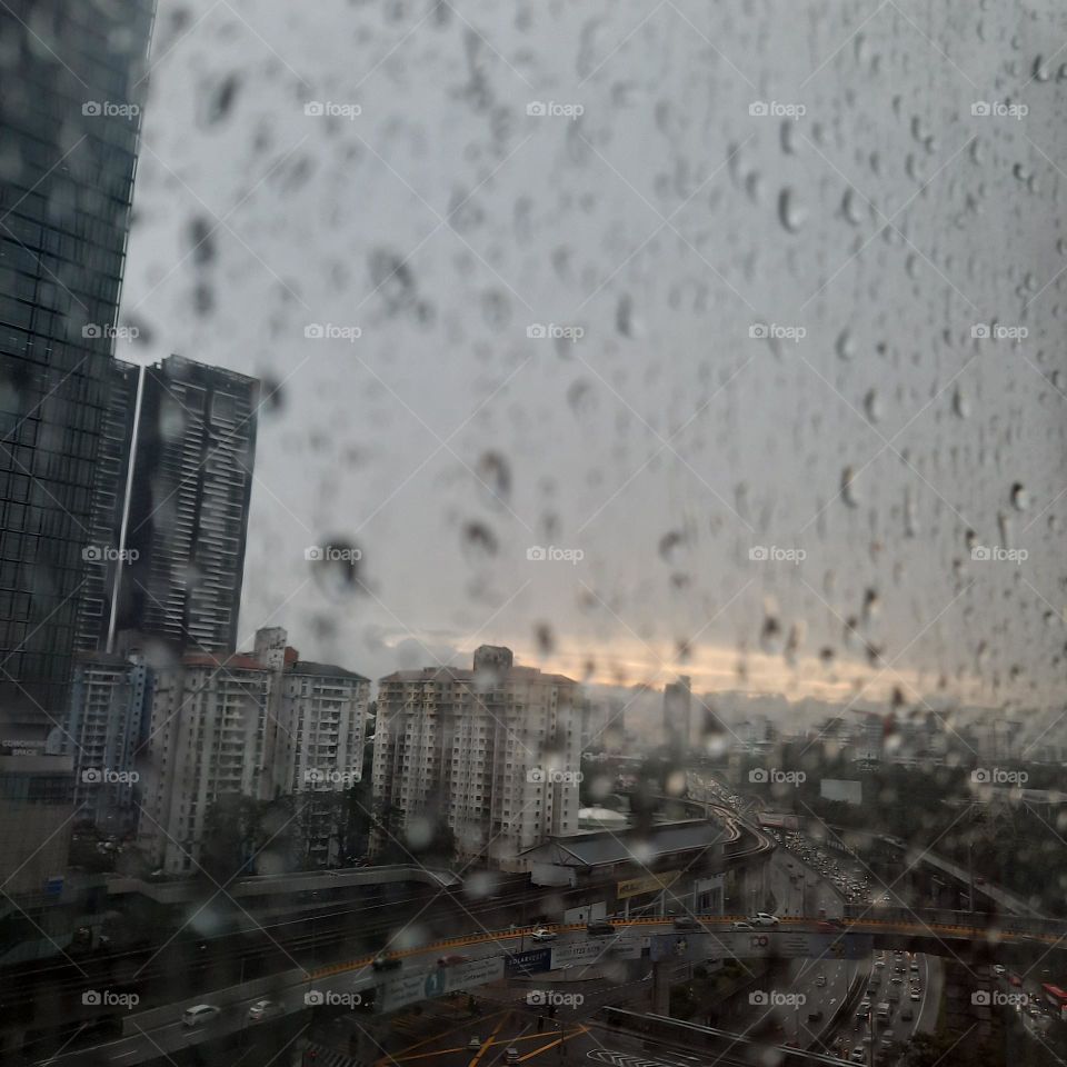 rain on the window overlooking city highway