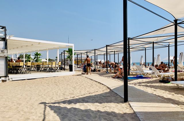 Beach season. Sun loungers on the beach. 