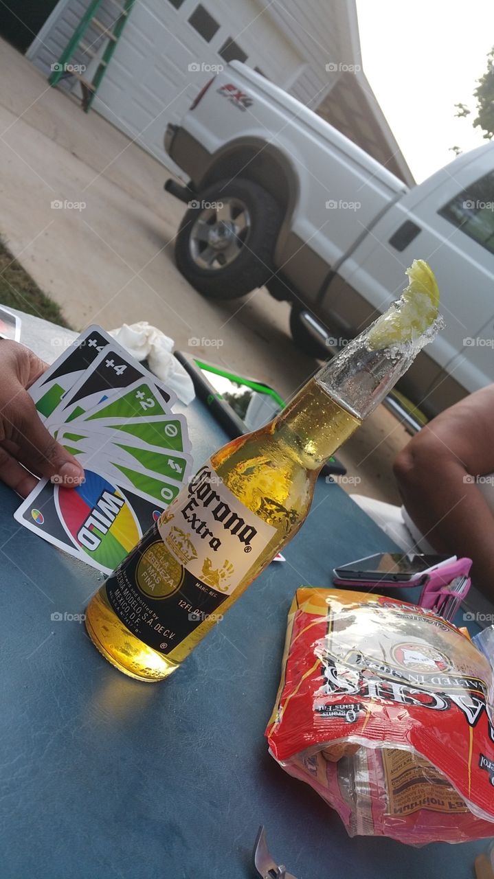 uno game. playing uno and having a corona extra