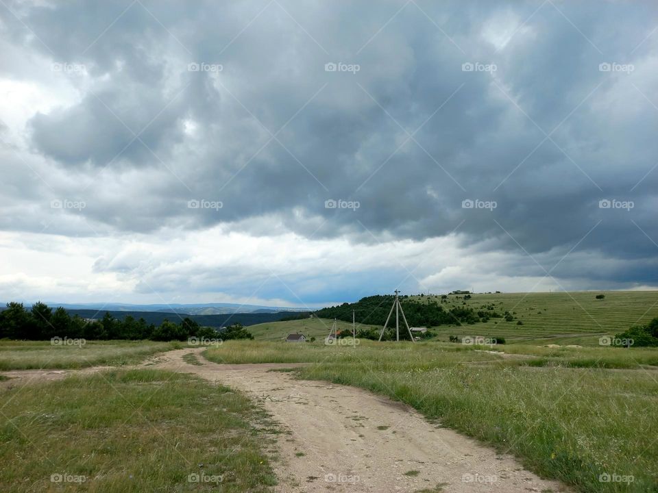 green valley and clouds in the sky.