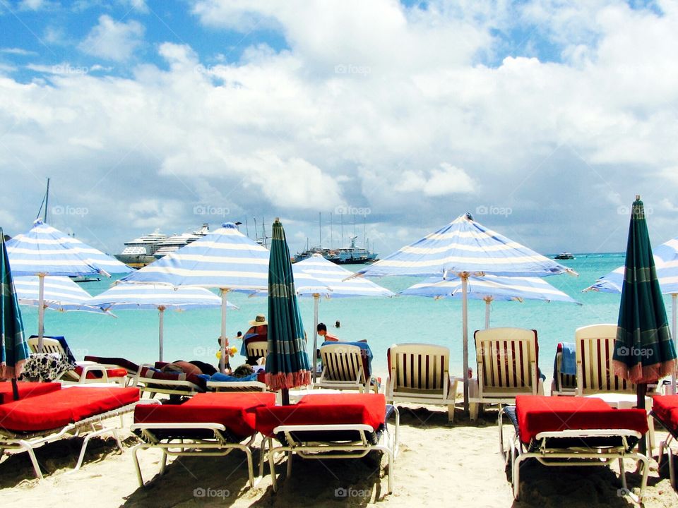 Red beach chairs in carribbean.