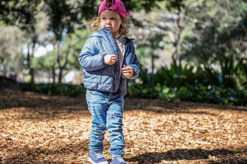 Cute little girl standing at park