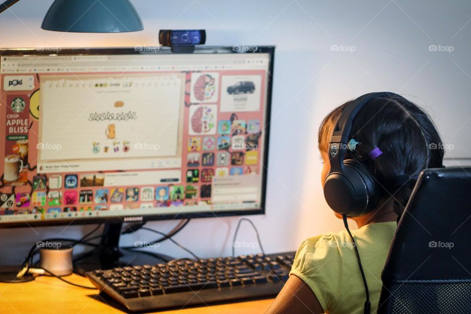 Girl is playing video games on a computer