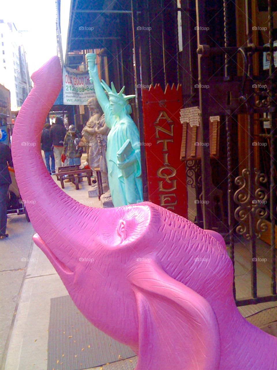 Pink Elephants on Parade. Pink elephant and Lady Liberty in front of an antique store in Chelsea, New York City