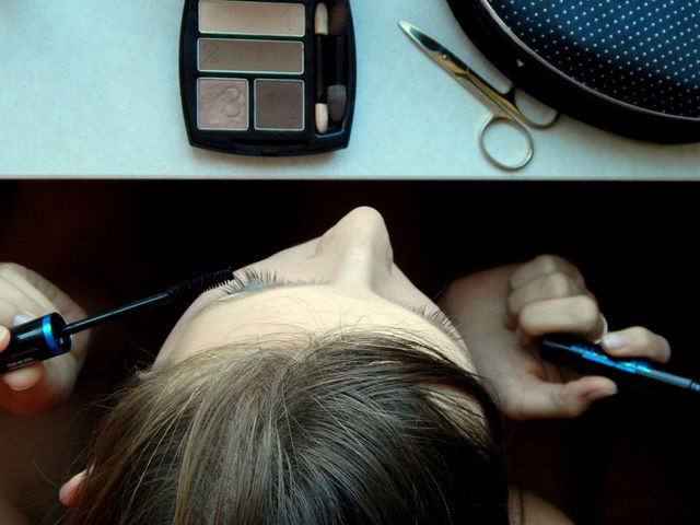 Young woman making make-up. View from above. Cosmetics to make-up.