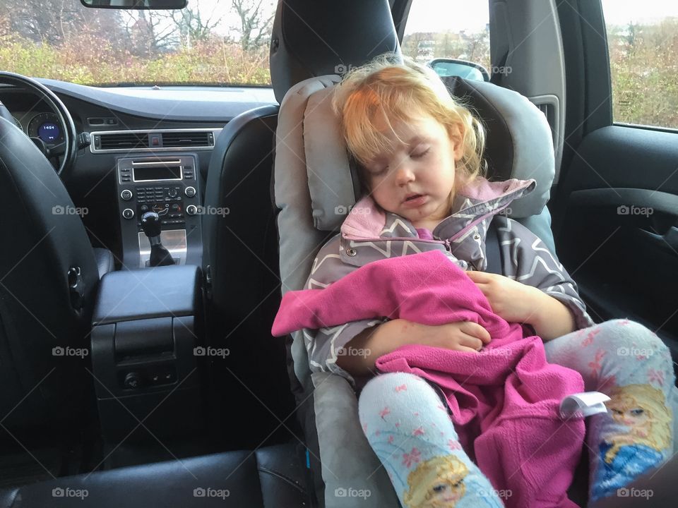 Sleeping little girl in the backseat of a car (volvo) 3 years old