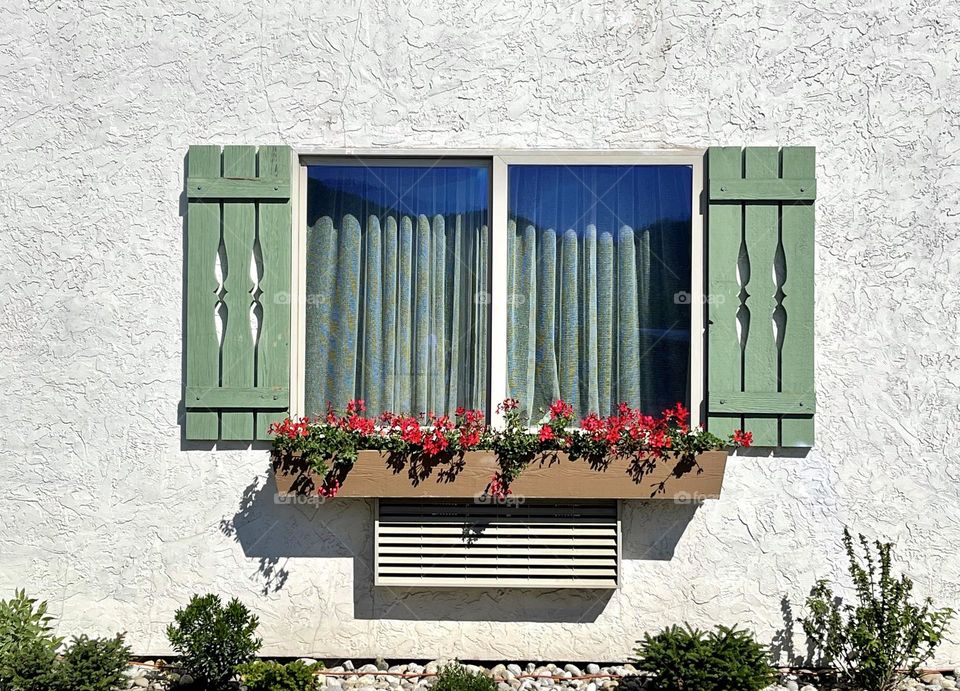 Window with curtains and wooden shades 