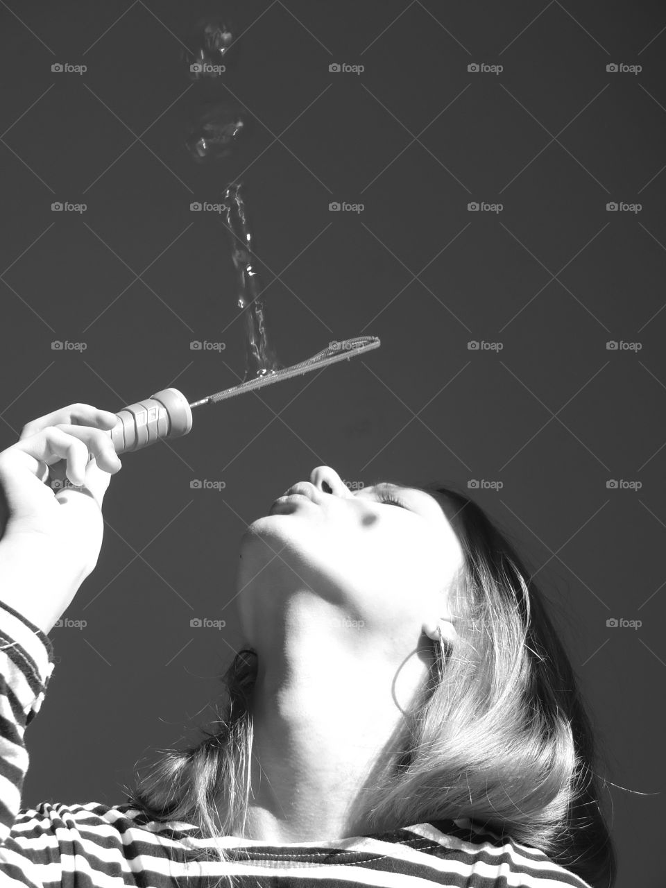Girl with soap bubbles. Soap bubbles. Black and white.