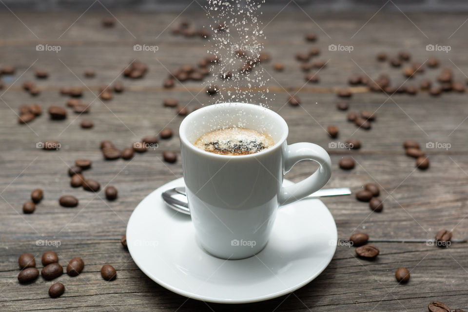 pouring sugar into espresso