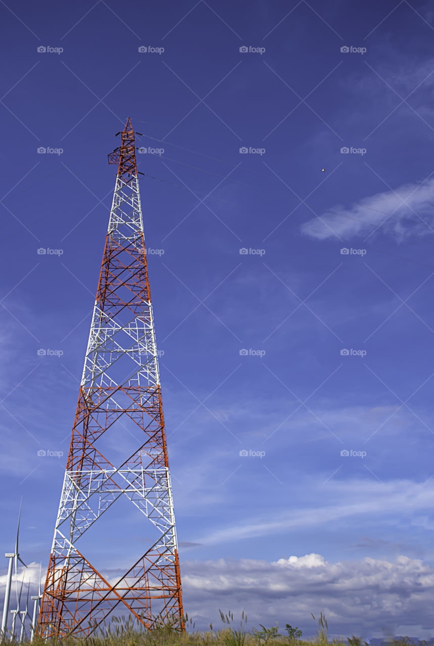 Wind turbines generate electricity and High voltage transmission towers on the Moutain at Khao Kho of phetchabun in Thailand.