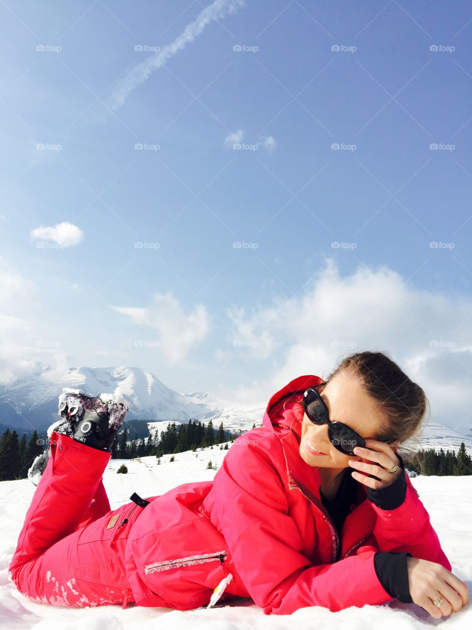 Woman lying on snowy landscape