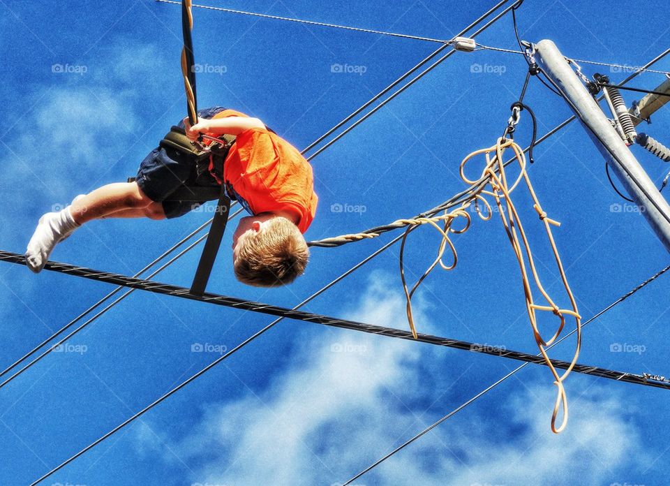 Acrobat Swinging On Wires