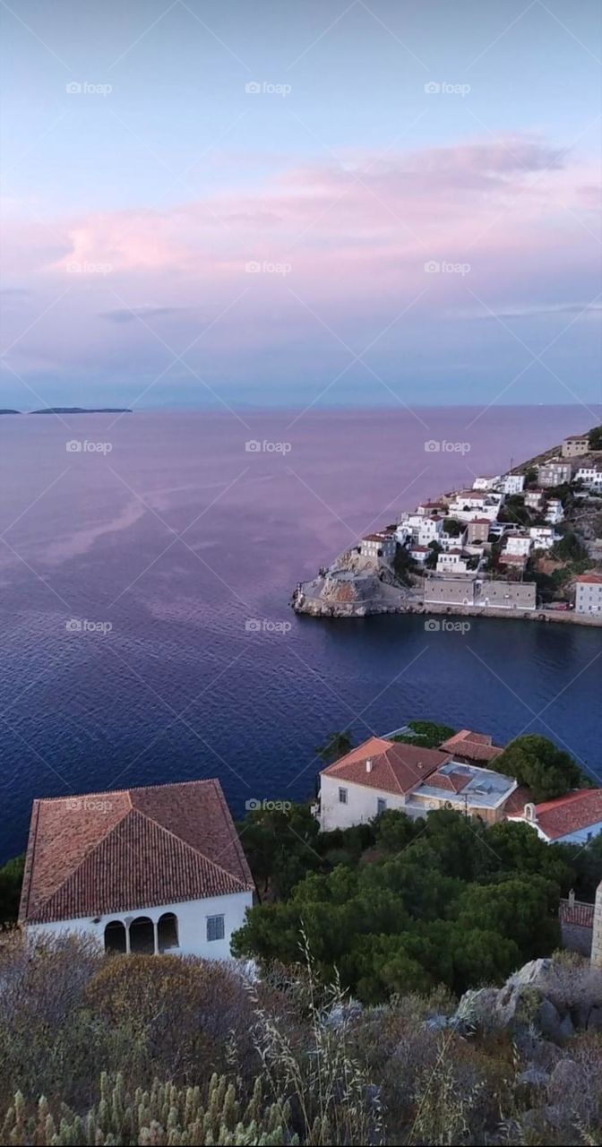 Sky colors reflecting at the sea creating this beautyful and romantic view from the top of the mountain.