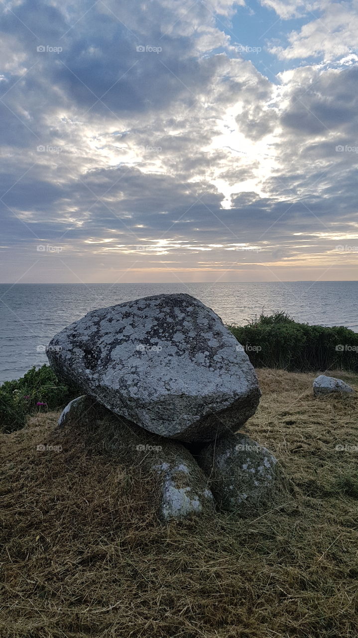 Peaceful landscape with a dolmen in foreground and the sea in background. Denmark.